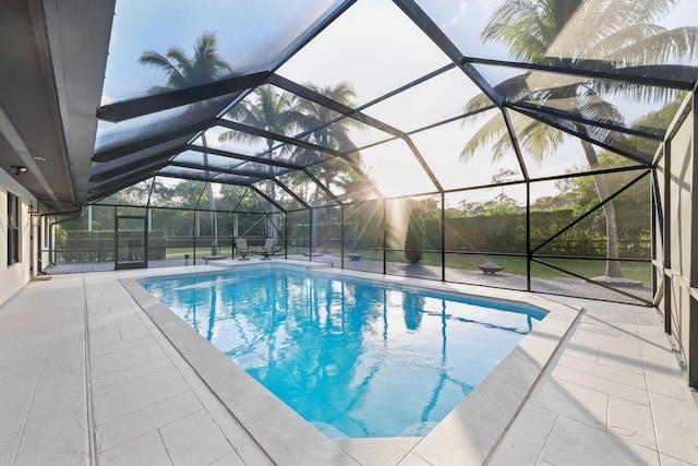 view of pool with a patio area and a lanai