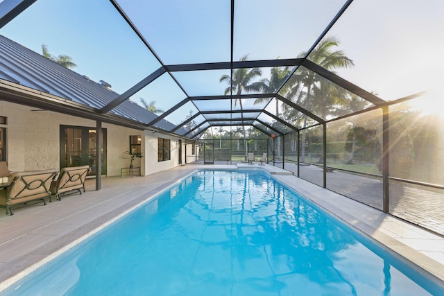 view of swimming pool featuring a lanai and a patio