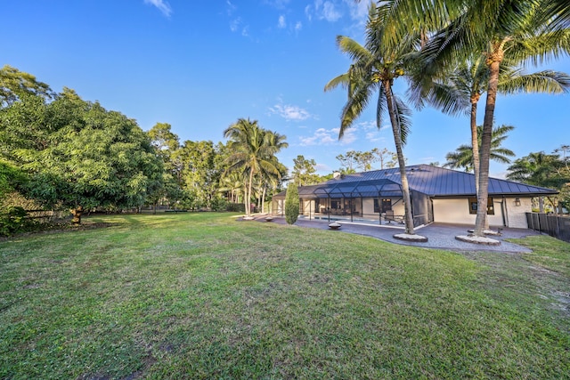 view of yard with a pool and a lanai