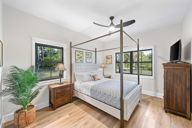 bedroom featuring multiple windows, light wood-type flooring, and ceiling fan