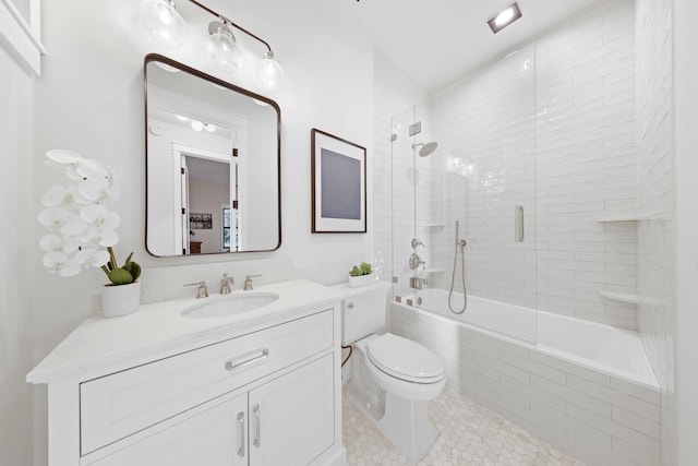 full bathroom featuring tile patterned flooring, vanity, bath / shower combo with glass door, and toilet