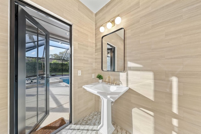 bathroom with tile walls