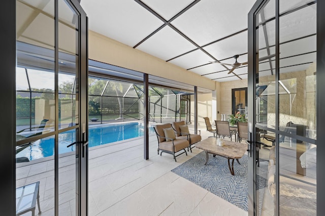 sunroom with french doors, a healthy amount of sunlight, and a pool