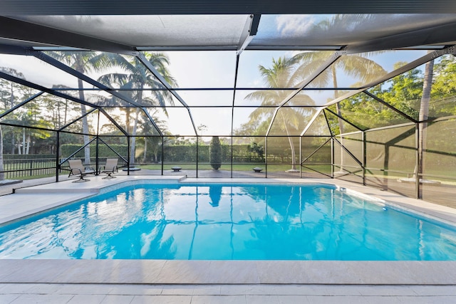 view of pool with a patio area and a lanai