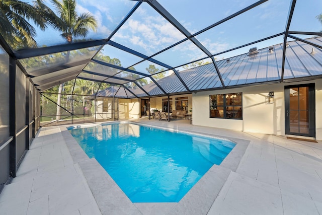 view of pool with a patio area and a lanai