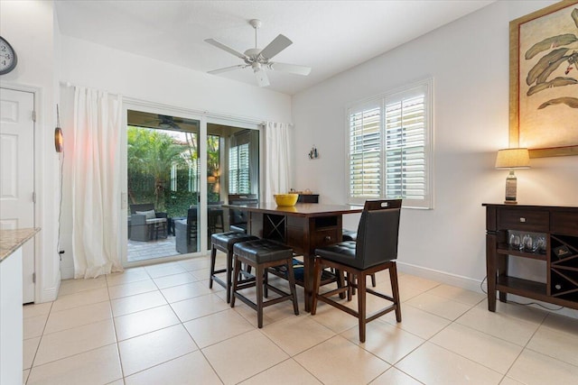 tiled dining room featuring ceiling fan