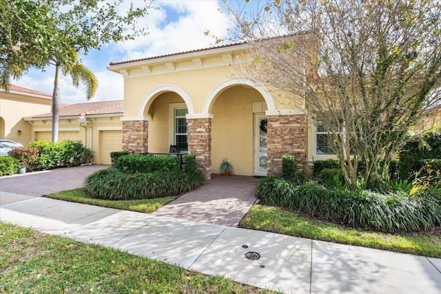 mediterranean / spanish house with a garage