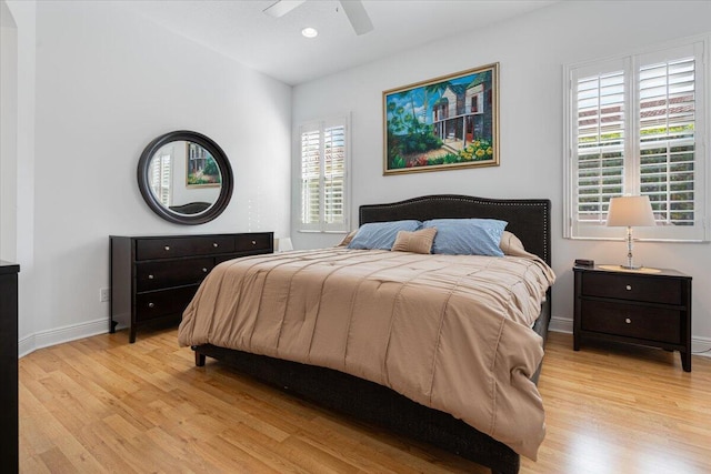 bedroom with multiple windows, ceiling fan, and light hardwood / wood-style flooring