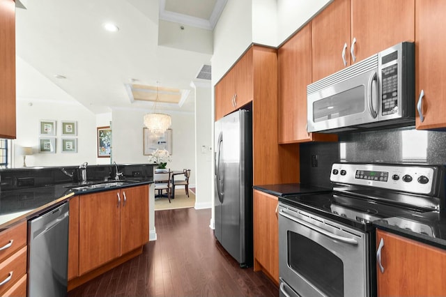 kitchen with tasteful backsplash, ornamental molding, stainless steel appliances, dark wood-type flooring, and sink