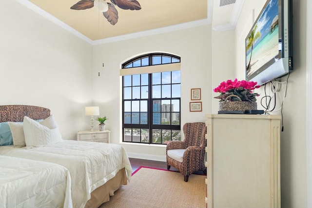 bedroom with ceiling fan, crown molding, and hardwood / wood-style flooring