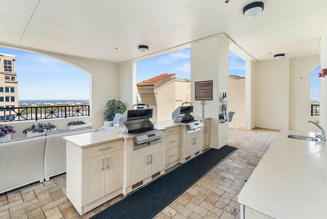 view of patio with exterior kitchen, sink, and grilling area