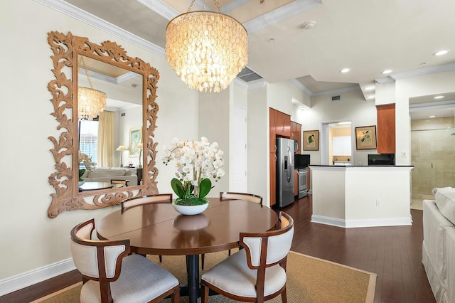 dining area featuring crown molding, dark hardwood / wood-style flooring, and a chandelier