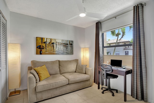 office featuring ceiling fan, light tile patterned floors, and a textured ceiling