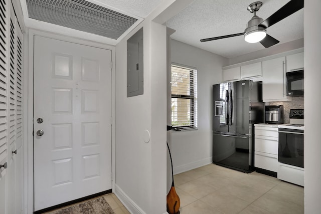 kitchen featuring white cabinets, light tile patterned floors, ceiling fan, and black appliances