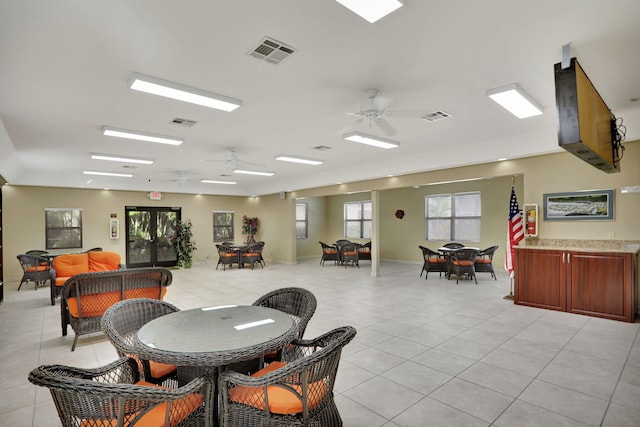 dining room with light tile patterned floors, french doors, and ceiling fan