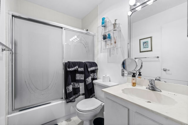 full bathroom featuring tile patterned flooring, vanity, toilet, and enclosed tub / shower combo