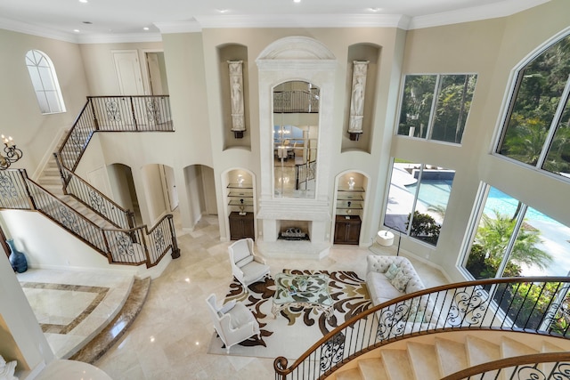 interior space with a towering ceiling and ornamental molding