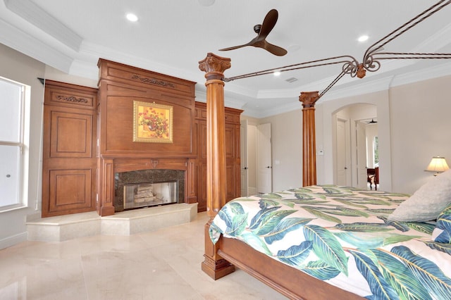 bedroom with ceiling fan, ornamental molding, and a premium fireplace