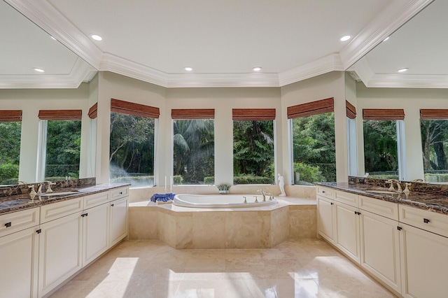 bathroom featuring tile patterned flooring, vanity, crown molding, and tiled tub