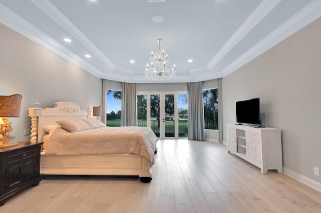 bedroom with ornamental molding, access to outside, a tray ceiling, light hardwood / wood-style flooring, and a notable chandelier