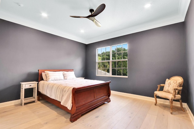 bedroom with ceiling fan, light hardwood / wood-style floors, and ornamental molding