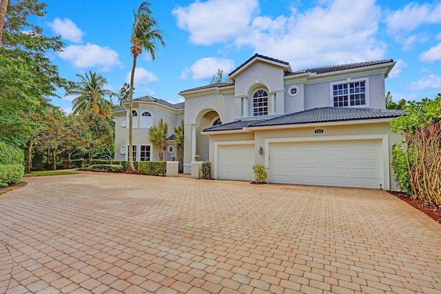 mediterranean / spanish-style home with a garage