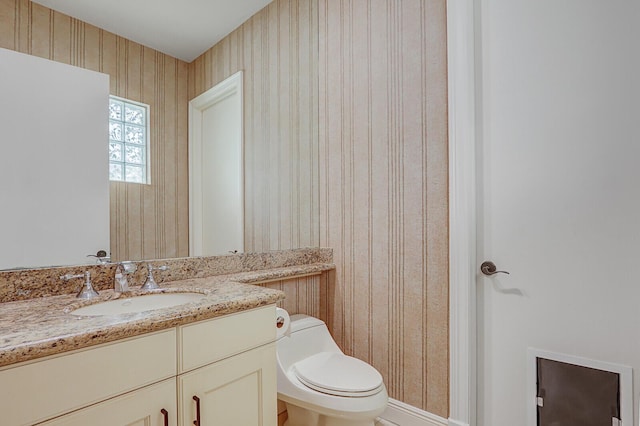 bathroom featuring vanity and toilet