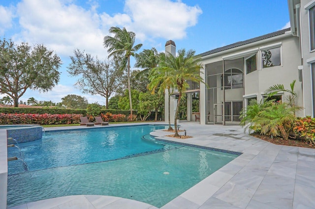 view of swimming pool with a patio, pool water feature, and central AC unit