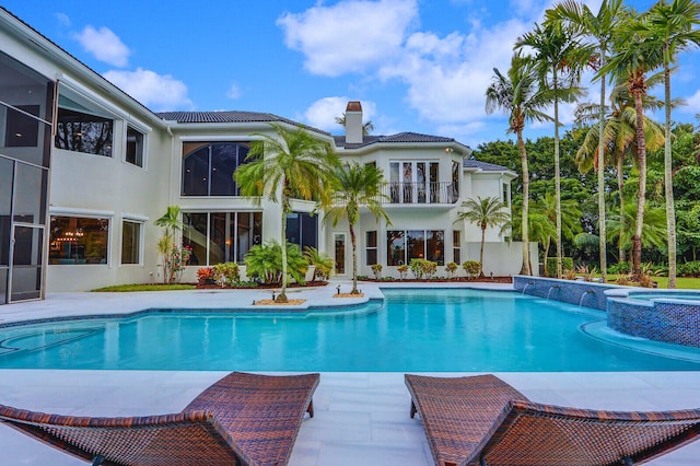 view of pool with an in ground hot tub