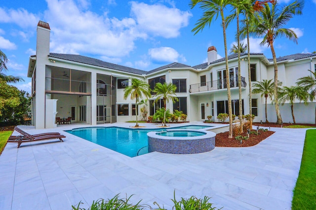 view of swimming pool featuring an in ground hot tub and a patio area