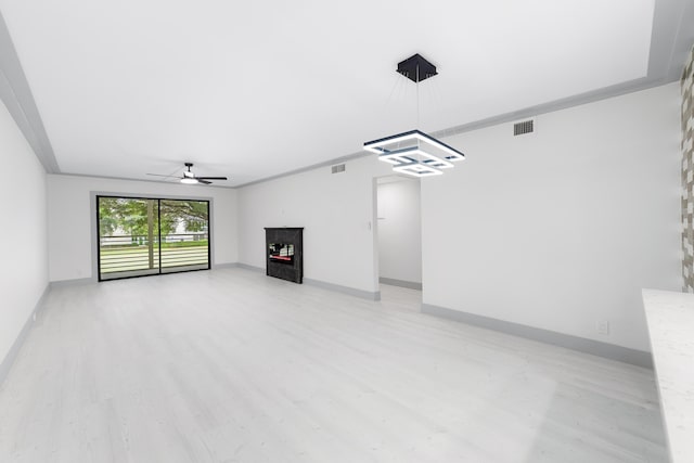 unfurnished living room featuring ceiling fan, light hardwood / wood-style floors, and crown molding