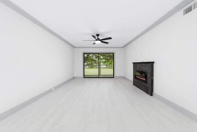 unfurnished living room featuring ceiling fan, light hardwood / wood-style floors, and ornamental molding