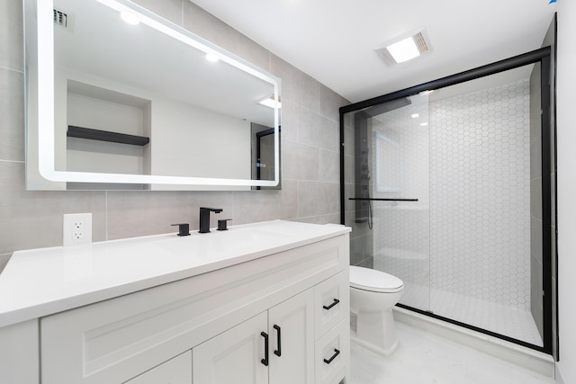 bathroom with vanity, decorative backsplash, toilet, tile walls, and an enclosed shower