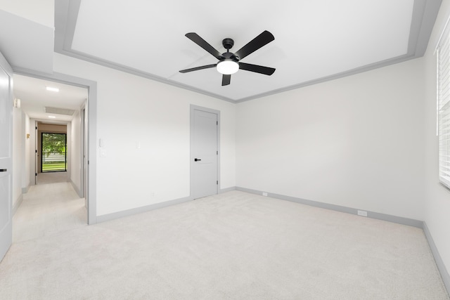 carpeted empty room featuring crown molding and ceiling fan