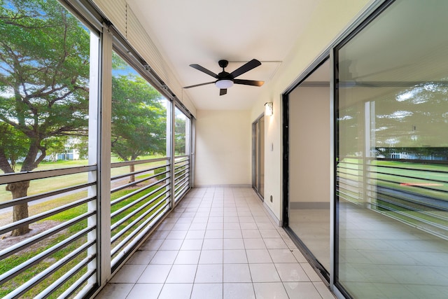 unfurnished sunroom with ceiling fan