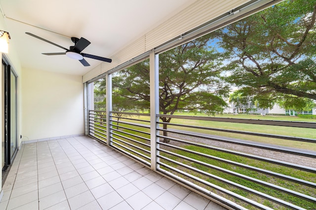 unfurnished sunroom featuring ceiling fan