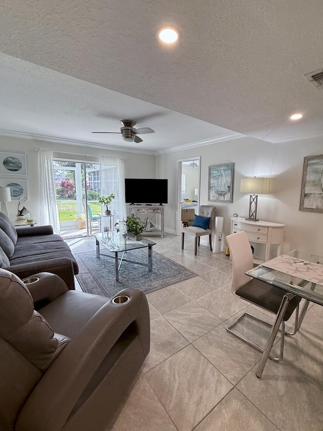 living room featuring ceiling fan, crown molding, and a textured ceiling