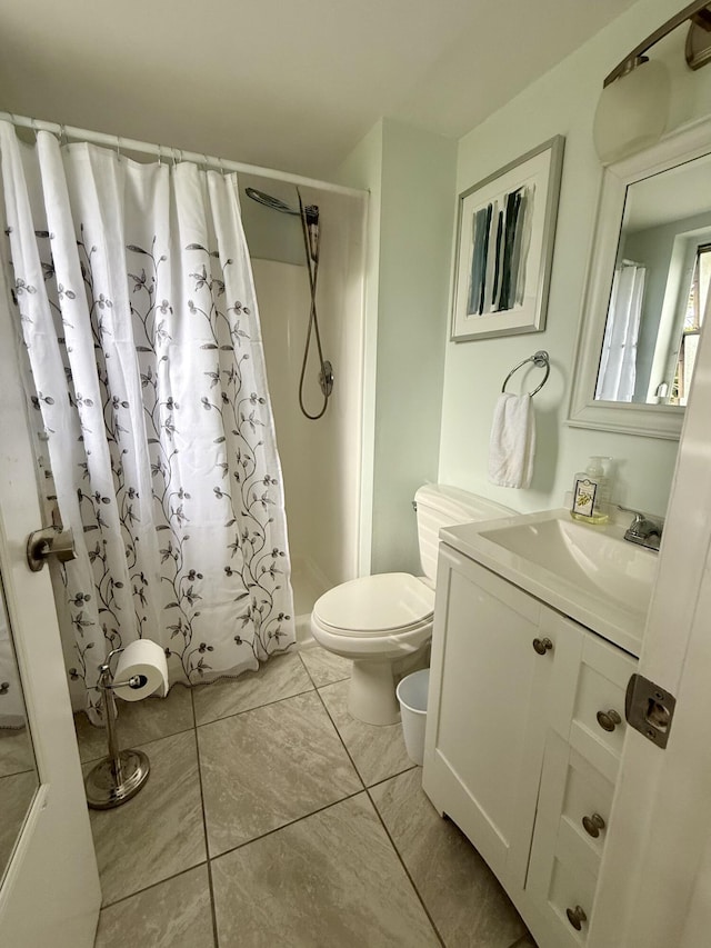 bathroom with tile patterned floors, toilet, vanity, and a shower with shower curtain