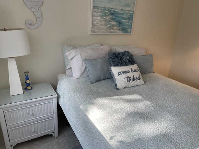 bedroom with dark tile patterned floors