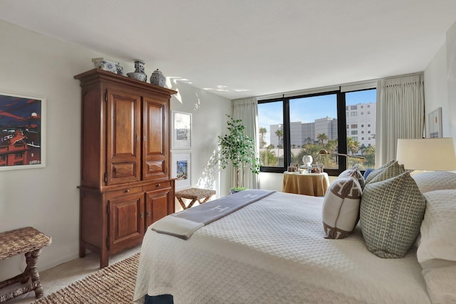 carpeted bedroom featuring floor to ceiling windows