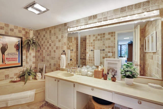 bathroom with vanity and tile walls