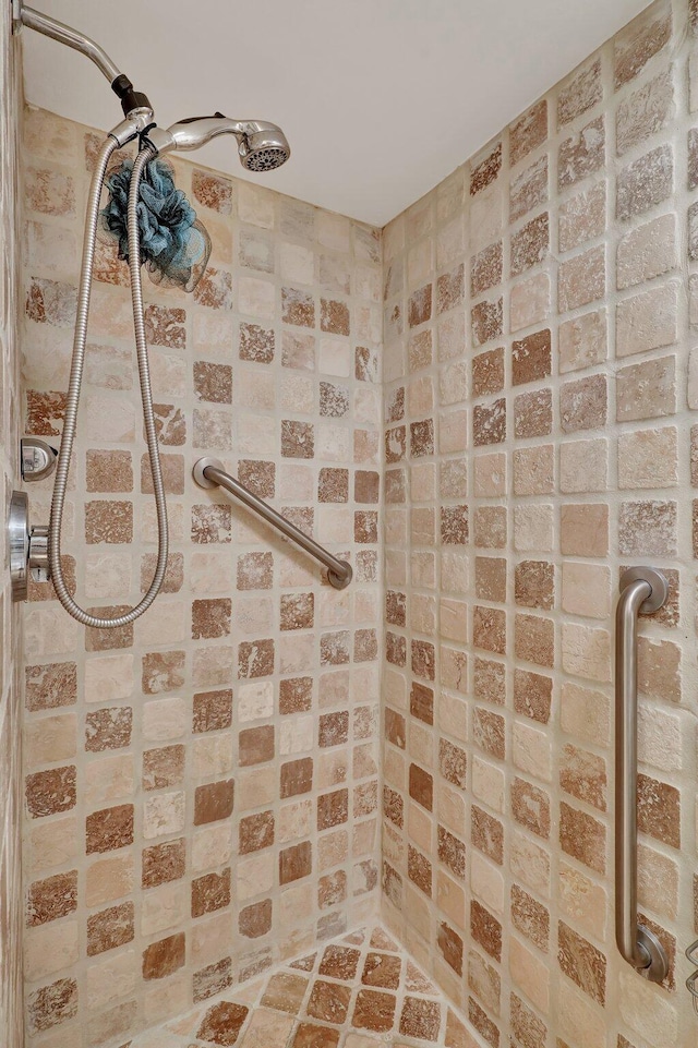 bathroom with a shower and brick wall