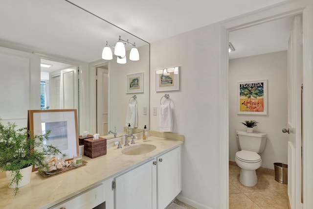 bathroom featuring tile patterned flooring, vanity, and toilet