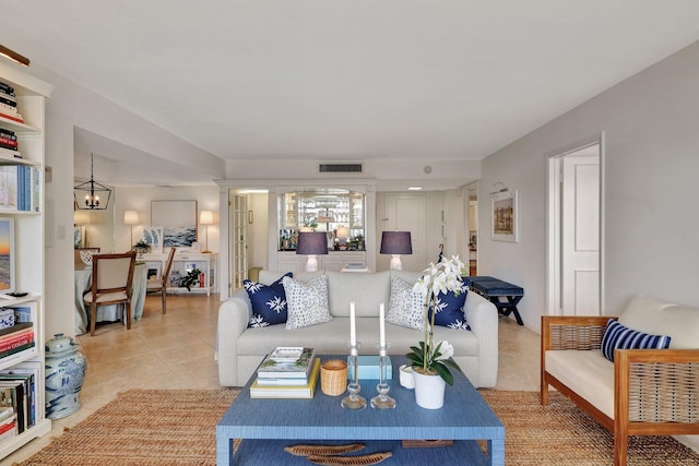 living room featuring a chandelier and light tile patterned flooring