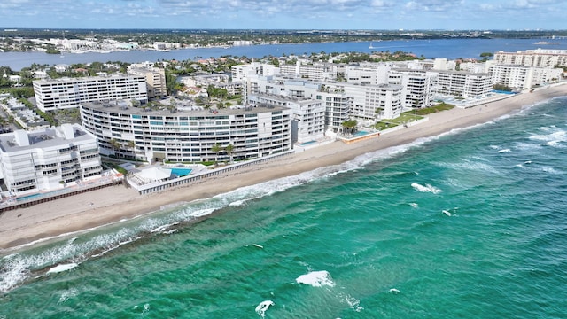 aerial view with a water view and a view of the beach