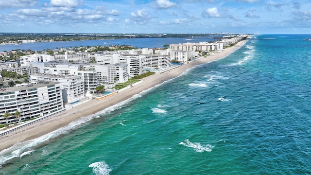 drone / aerial view with a water view and a beach view