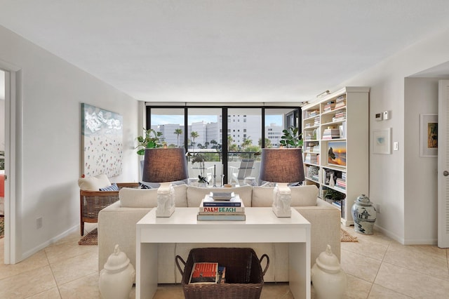 living room featuring expansive windows and light tile patterned flooring