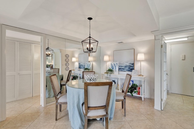 tiled dining space with an inviting chandelier