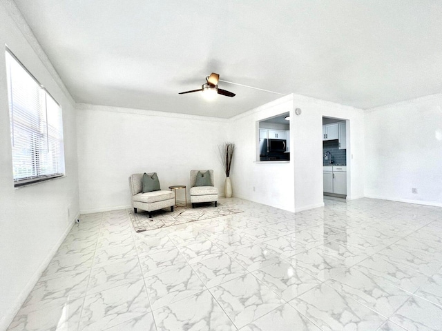 unfurnished room featuring ceiling fan and sink