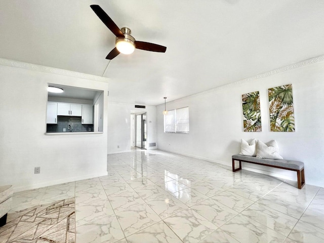 unfurnished living room featuring ceiling fan and crown molding